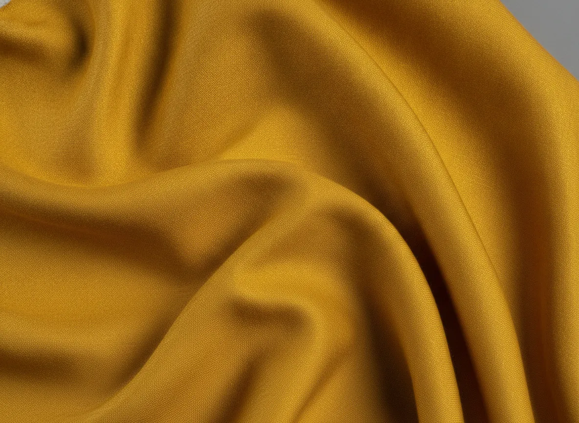 Close view of yellow fabric texture under editorial studio lighting