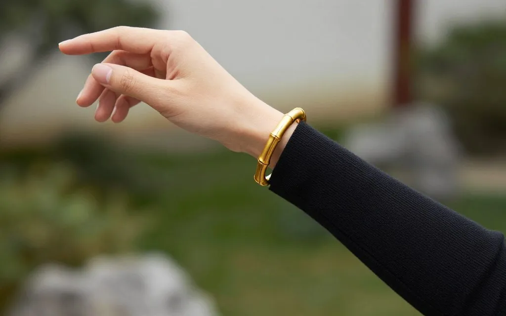 Bamboo cuff yellow gold styled with a fine knit